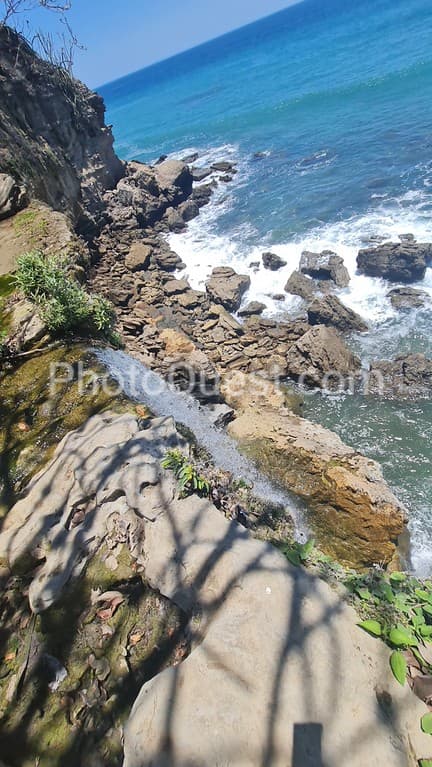 Waterfall into the ocean in a rock formations in Montezuma Nicoya Peninsula Costa Rica