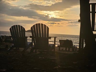 Beach chairs at sunset offer relaxation and escape.